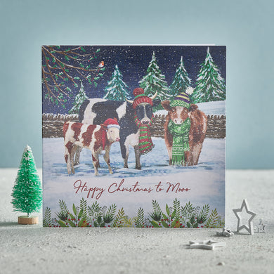 A Christmas card showing three cows wearing wooly hats in the snow