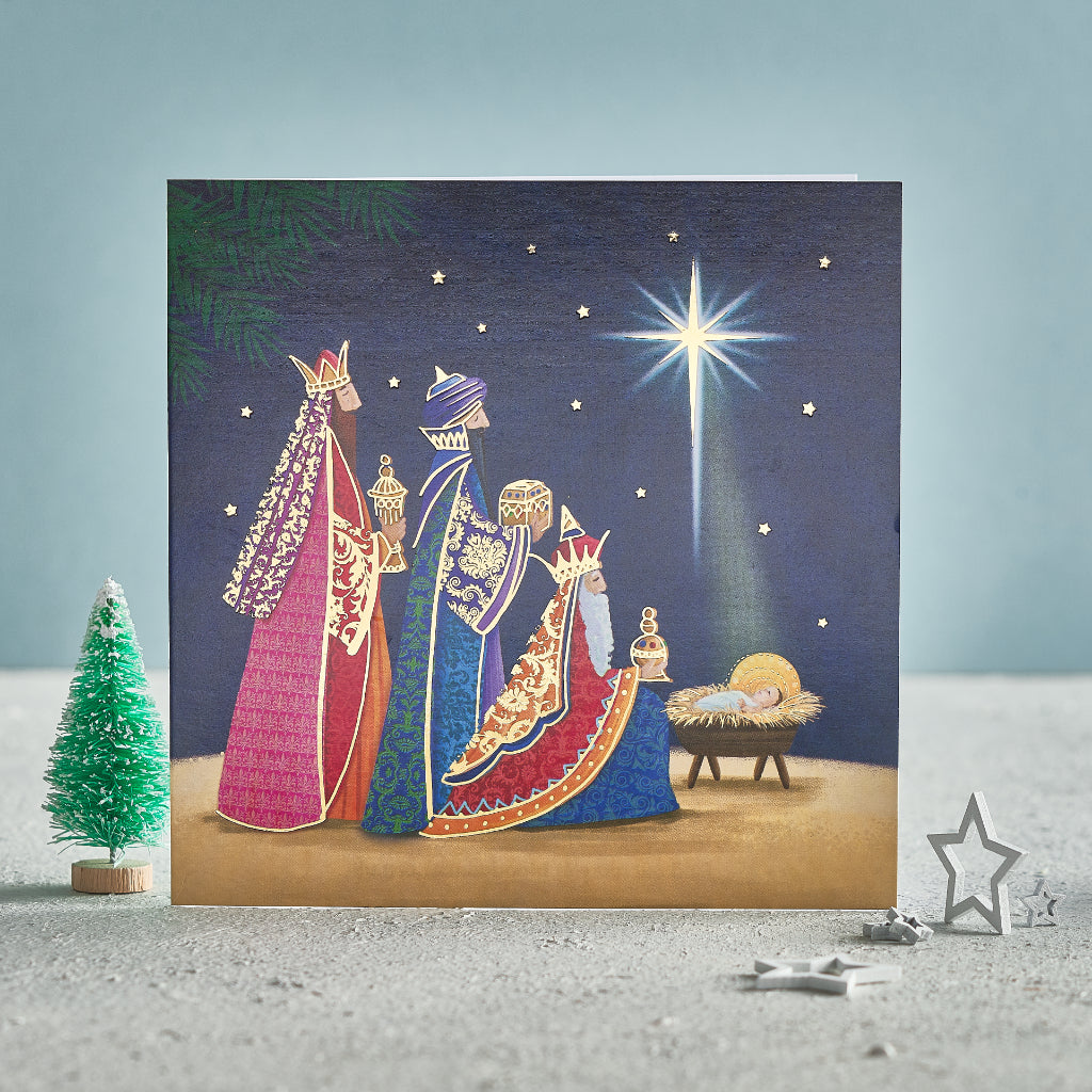 A Christmas card showing three kings giving gifts to the baby Jesus