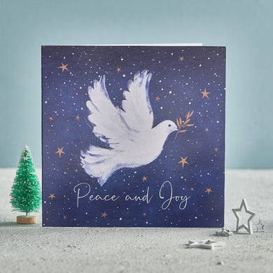  A Christmas card with a dove on the front, flying in the night sky. The text on the front of the card reads 'Peace and Joy'