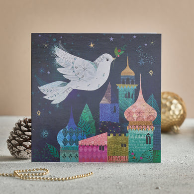 A Christmas card with a dove flying over a Bethlehem sky. 