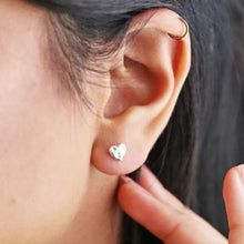 Load image into Gallery viewer, Close-up of an ear with a heart-shaped earring and a blurred background